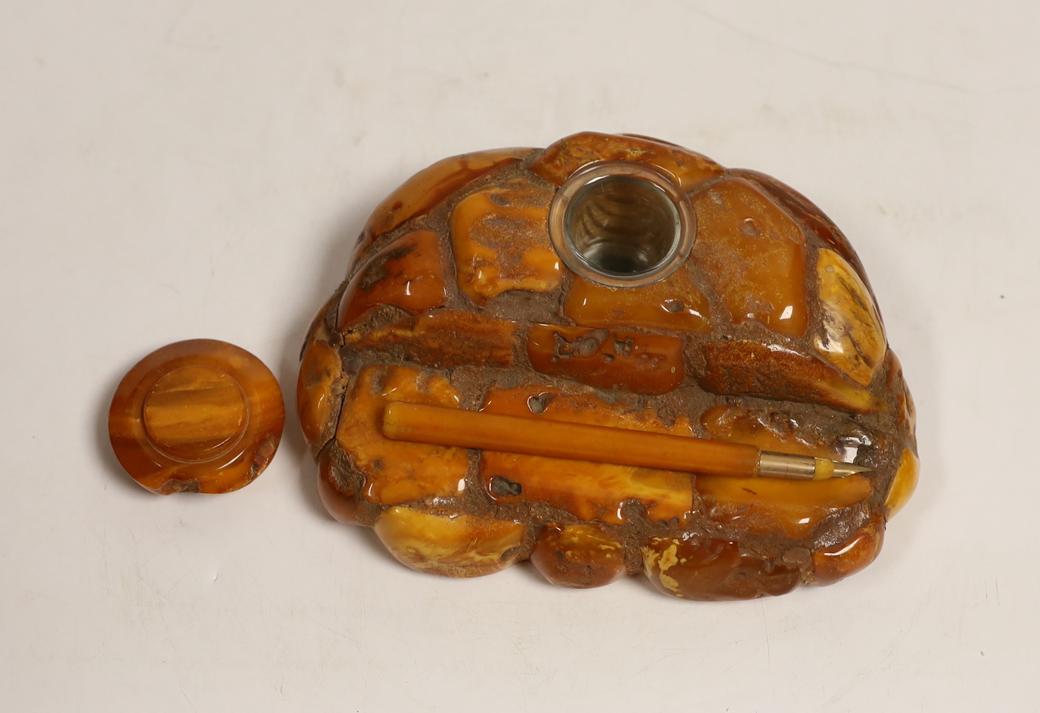 A carved amber inkstand, 15.5cm wide